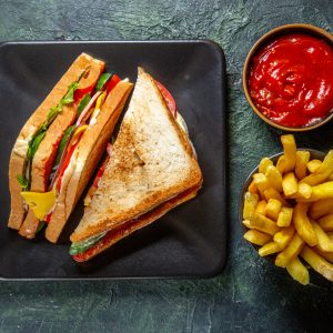 top-view-yummy-ham-sandwich-inside-dark-plate-with-french-fries-ketchup-dark-surface